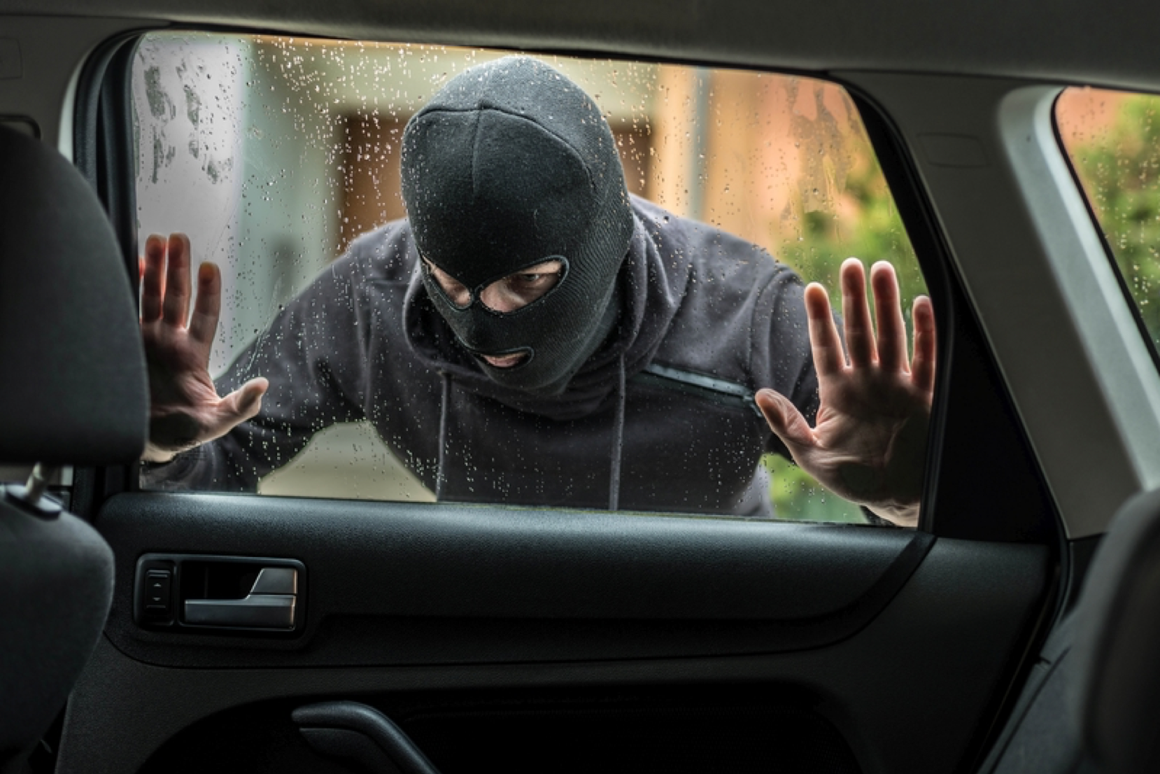thief looking through car window