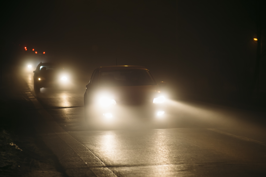 Cars,In,A,Fog,During,Night,With,Shining,Headlights