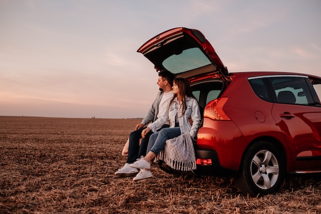couple sitting in boot of car